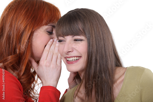 Photo: Two friends gossiping. Two friends gossiping.
