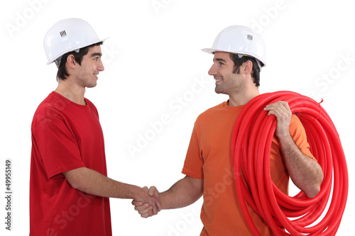 Photo: Two electricians shaking hands Two electricians shaking hands