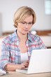 Woman using a laptop computer at home