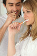 Couple brushing their teeth