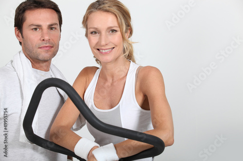 Photo: Couple working out in a gym Couple working out in a gym