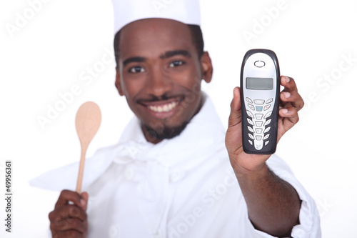 Photo: A black chef handing the phone over. A black chef handing the phone over.