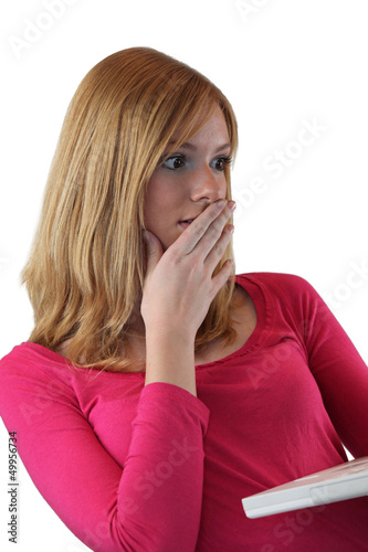 Photo: Shocked woman holding a laptop Shocked woman holding a laptop