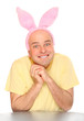 An happy man with pink rabbit ears. Happy easter concept.