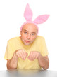 An happy man with pink rabbit ears. Happy easter concept.