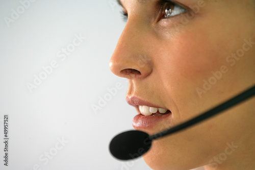 Photo: Close-up of brunette wearing head-set Close-up of brunette wearing head-set