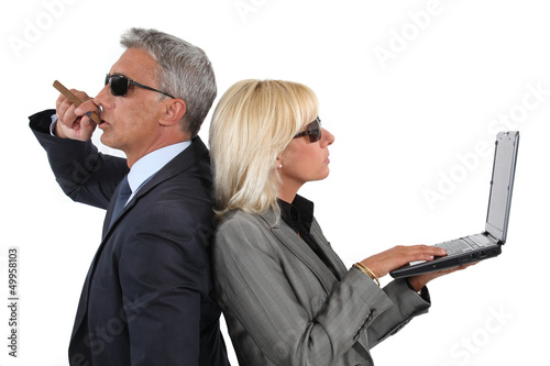 Photo: Cocky businessman and businesswoman Cocky businessman and businesswoman