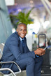 happy male african business traveller in airport
