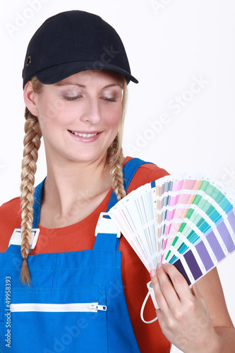 Photo: Woman choosing which color paint to use Woman choosing which color paint to use