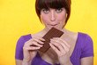 Woman with a bar of chocolate