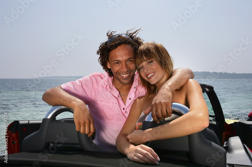 Photo: Happy couple in a convertible car Happy couple in a convertible car