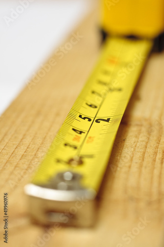 Photo: Tape measure on wood Tape measure on wood