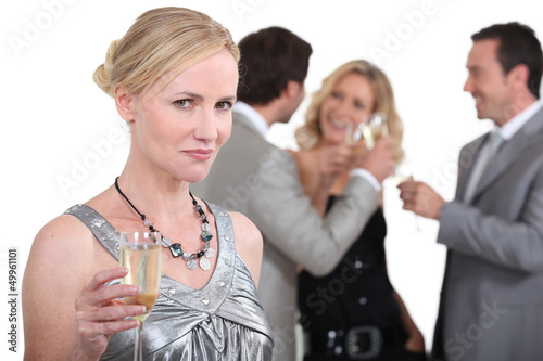 Photo: Blond woman holding up champagne Blond woman holding up champagne