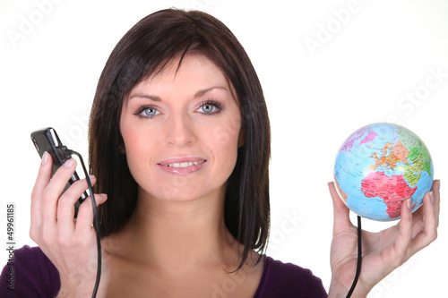 Photo: Woman holding globe and telephone Woman holding globe and telephone