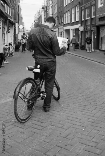 Photo: Tourist Exploring Amsterdam on Bike Tourist Exploring Amsterdam on Bike