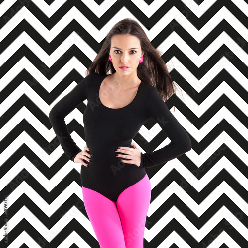 Photo: Brunette woman intense portrait on retro black and white stripes Brunette woman intense portrait on retro black and white stripes