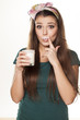 girl in a green shirt with a pleased gesture drinking milk