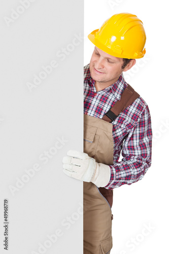 Photo: Construction worker presenting empty banner Construction worker presenting empty banner