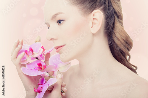 Photo: Beautiful Girl With Orchid Flowers Beautiful Girl With Orchid Flowers