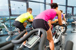 Group of women and men Spinning in gym for fitness