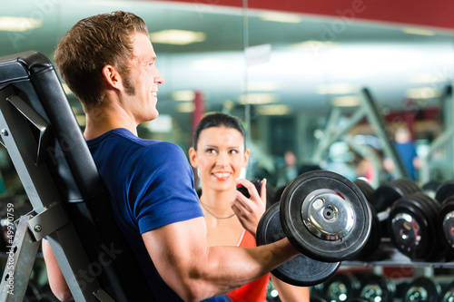 Photo: Personal Trainer in gym and dumbbell training Personal Trainer in gym and dumbbell training