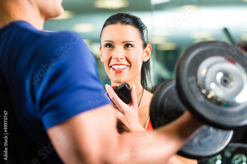 Photo: Personal Trainer in gym and dumbbell training Personal Trainer in gym and dumbbell training