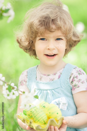 Photo: Child holding Easter eggs Child holding Easter eggs