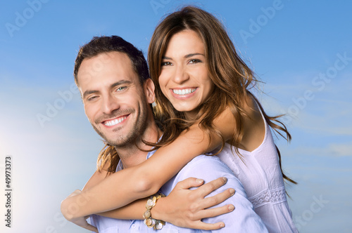 Photo: Young Man Carrying Woman On Back Young Man Carrying Woman On Back