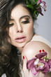 Beauty Girl With Orchid Flowers.Beautiful Model Woman Face. Perf