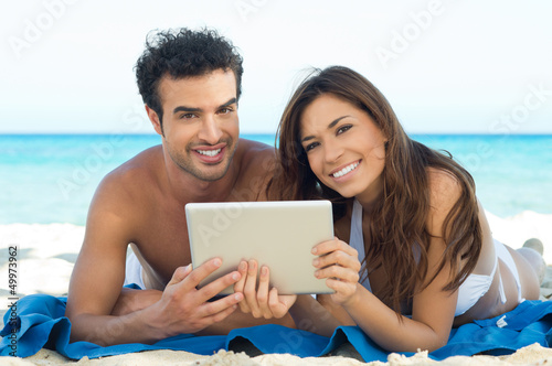 Photo: Happy Couple With Digital Tablet Happy Couple With Digital Tablet