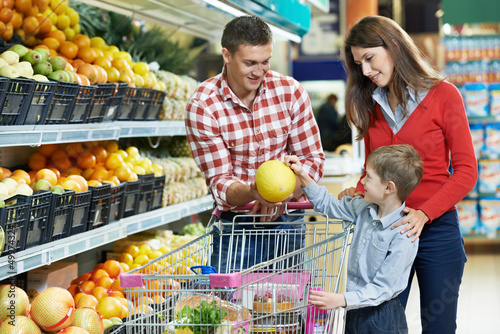 Photo: Family with child shopping fruits Family with child shopping fruits