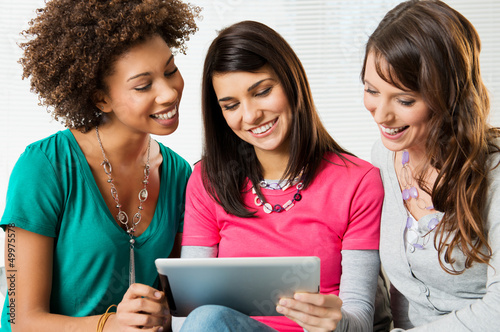 Photo: Girls Looking At Digital Tablet Girls Looking At Digital Tablet