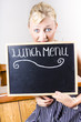 Hungry woman eating a cafe lunch menu