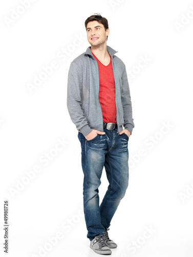 Photo: happy handsome man in grey jacket and blue jeans happy handsome man in grey jacket and blue jeans