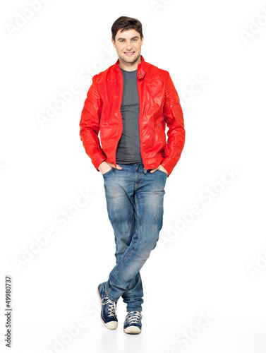 Photo: Smiling happy man in red jacket, blue jeans and gymshoes. Smiling happy man in red jacket, blue jeans and gymshoes.