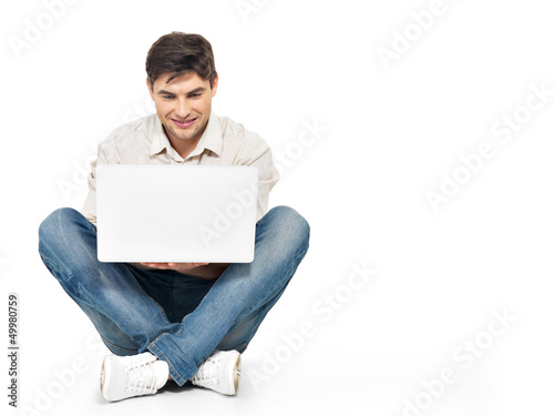 Photo: Portrait of happy man working on laptop Portrait of happy man working on laptop