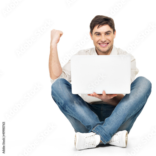Photo: happy successful man working on laptop happy successful man working on laptop