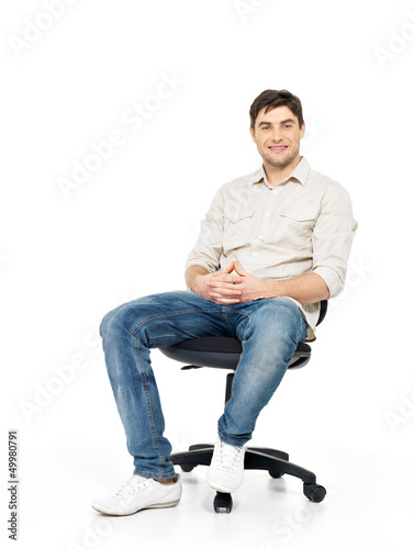 Photo: Portrait of smiling happy man sits on office chair Portrait of smiling happy man sits on office chair