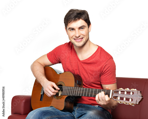 Photo: Smiling guitarist plays on the acoustic guitat Smiling guitarist plays on the acoustic guitat