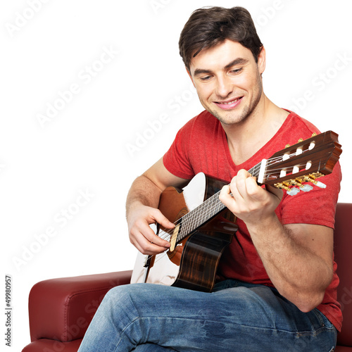 Photo: Smiling guitarist plays on the acoustic guitat Smiling guitarist plays on the acoustic guitat