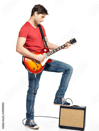 Photo: Guitarist man plays on the electric guitar Guitarist man plays on the electric guitar