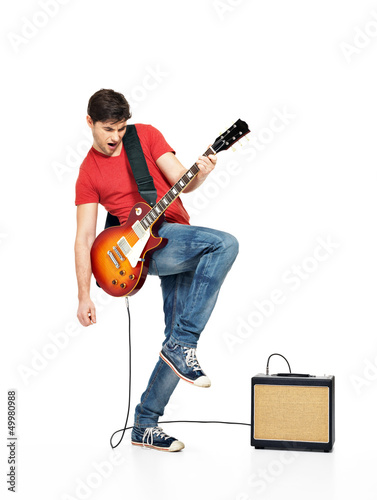 Photo: Guitarist man plays on the electric guitar Guitarist man plays on the electric guitar
