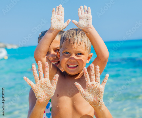 Photo: Girl and boy On Sand Girl and boy On Sand