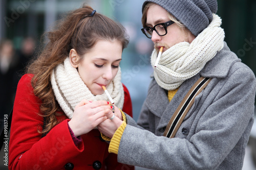 Photo: Young couple with cigarettes Young couple with cigarettes