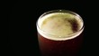 Pilsner of red beer high angle.