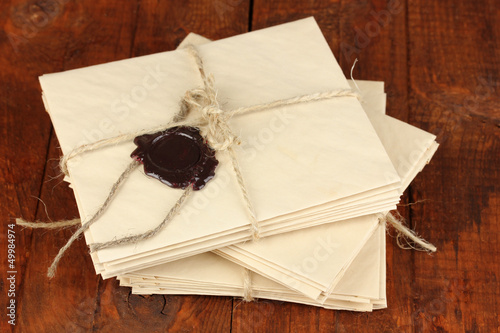 Photo: Stacks of old letters on wooden table Stacks of old letters on wooden table