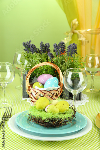 Photo: Easter table setting on color background Easter table setting on color background