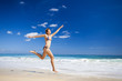 Woman jumping on the beach