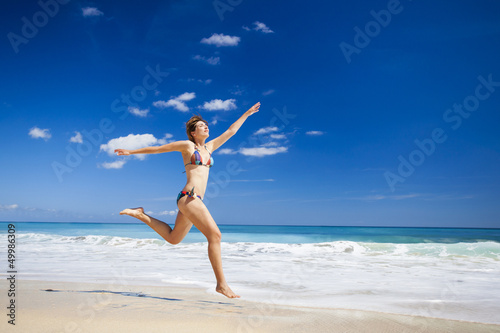 Photo: Woman jumping on the beach Woman jumping on the beach