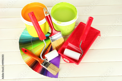 Photo: Set for painting: paint pots, brushes, paint-roller Set for painting: paint pots, brushes, paint-roller